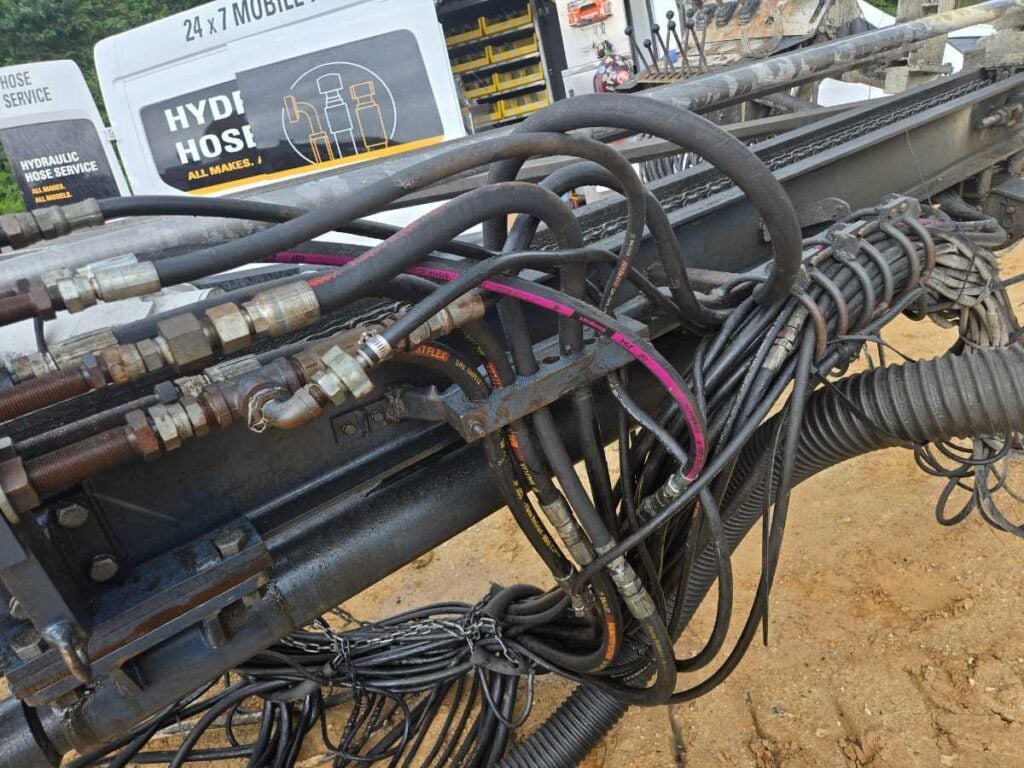 Hydraulic Hose Assembly on A Piece of Heavy Equipment with the Mobile Van in the Background